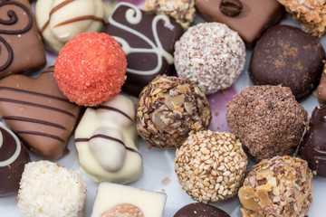 Top view on different of delicious chocolate candies, white, dark, and milk chocolate.