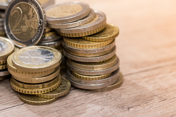 Euro coins in group on a wooden desk