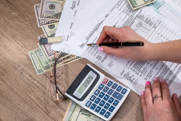 woman filling tax forms. 2017