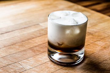 White Russian Cocktail on wooden surface.