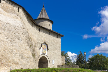 Fototapeta premium View on old Pskov Kremlin wall with gate