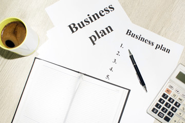 An inscription of the business plan, execution points, there is a notebook and a calculator next to it
