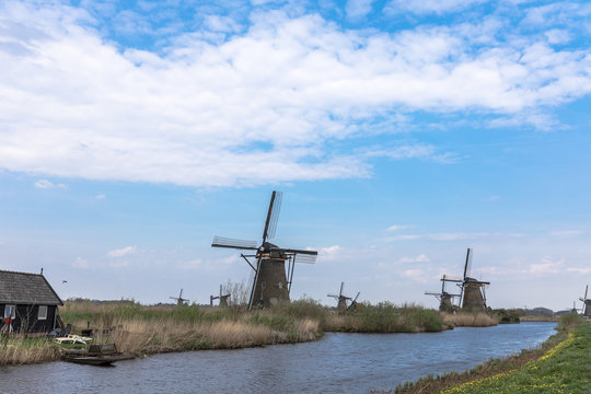 Windmills At A Small River At Kinderdijke Netherlands