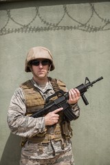 Fototapeta premium Military soldier standing with a rifle