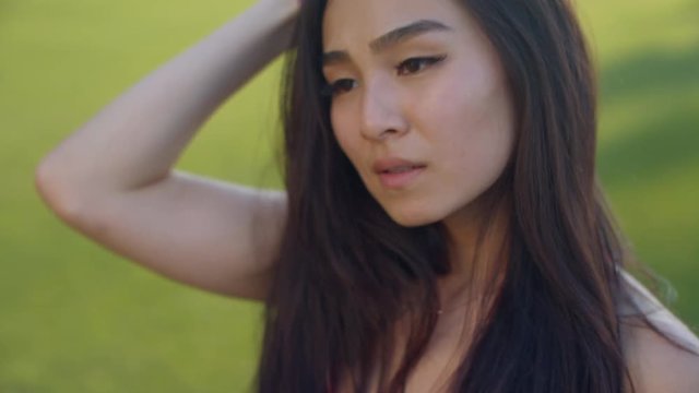 Asian girl close up. Sexy woman face. Closeup of sensual woman flirting with camera. Chinese girl portrait outdoors. Close up of sexual woman face. Asian woman portrait