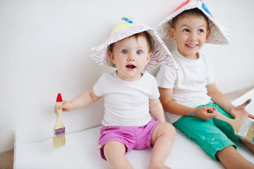 happy children painting wall at home