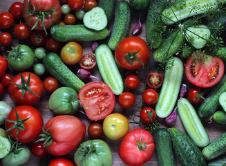 Fototapeta na wymiar red tomatoes and green cucumbers, top view.