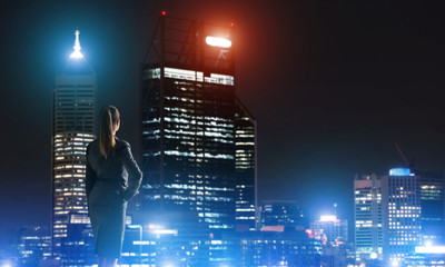 Fototapeta premium Woman looking at night city