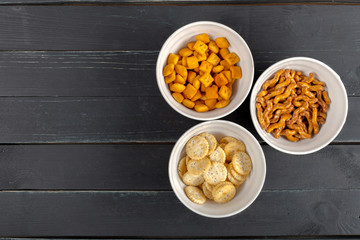 Pretzels in bowls on wooden table from above