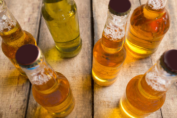 Beer bottles on a wooden table .
