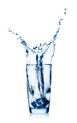 Fototapeta na wymiar Splash of water in a glass with ice