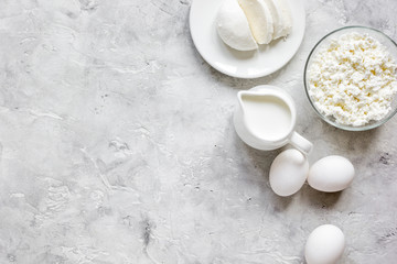 monochrome concept with dairy products on stone table top view mock up