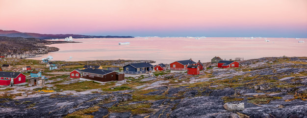 Panoramic views of Disko Bay with icebergs from the village Quaatsut summer night. The source of these icebergs is the Jakobshavn glacier, Greenland © vadim_petrakov