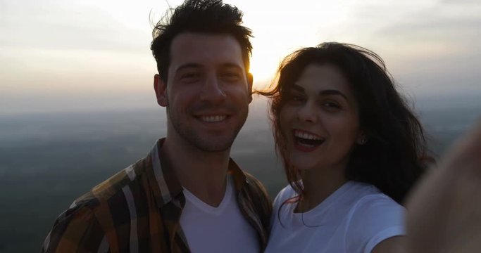 Couple On Mountain Top Taking Selfie Photo At Sunrise, Tourists Man And Woman Happy Smiling Slow Motion 60