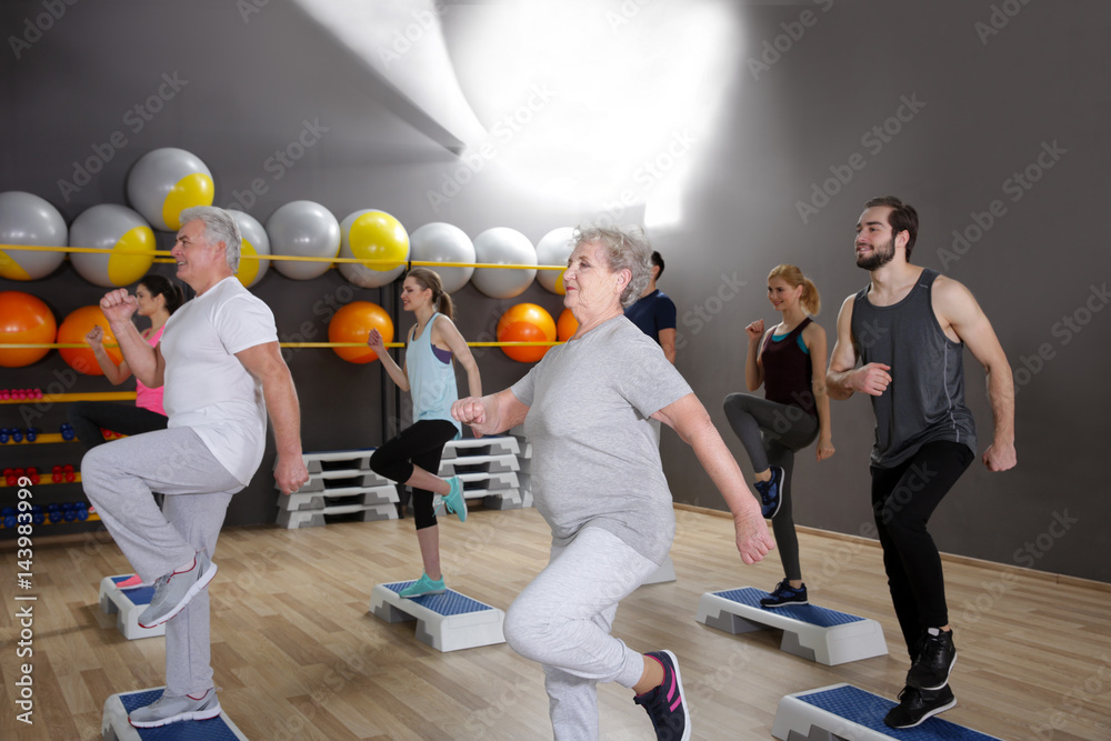 Sticker people of different ages training in gym