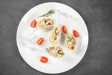 Plate with stuffed pasta on table