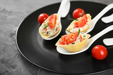 Plate with stuffed pasta on table
