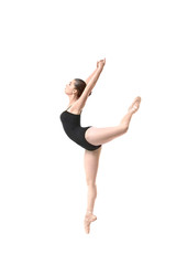 Young beautiful ballerina dancing on white background