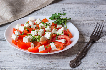 Fresh salad with tomato, mozzarella and herbs.