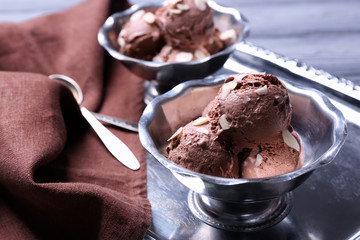Tasty ice-cream in bowls on tray
