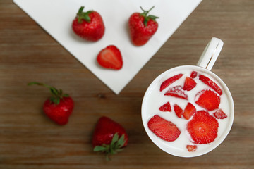 Ceramic Cup of Yogurt,Red Fresh Strawberries,White Napkin are on the Wooden Background.Breakfast Organic Healthy Tasty Food.Cooking Vitamins Ingredients.Summer Fruits.Top View