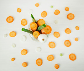 Green fresh onion and orange carrot on the white wooden background.Vegetables.
