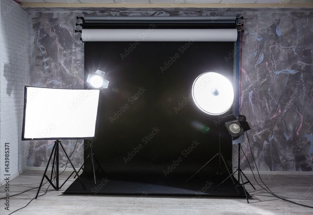 Wall mural Modern photo studio interior with professional lighting equipment