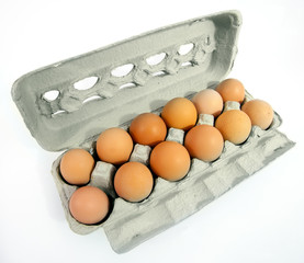 One dozen free range brown eggs in an open carton.