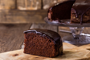 Slice of homemade chocolate cake on wooden table - 143986175