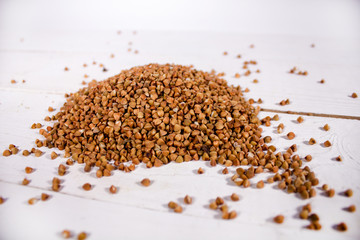 Buckwheat on white wooden surface closeup