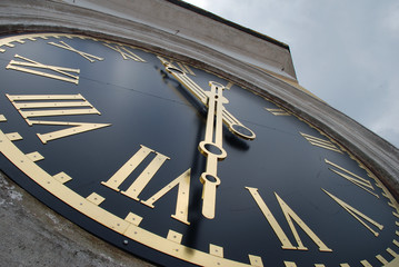 Сlock face of the Clock Tower with golden hands and Roman numerals