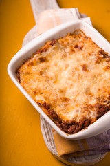 Homemade Meat lasagna on wooden stand top view