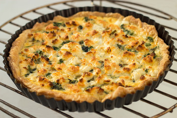Homemade quiché with chicken, goat cheese and spinach. Selective focus