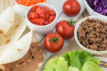 Ingredients for homemade taco salad with spicy beef, refried beans.