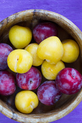 Plums in a wooden bowl