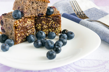 Currant cake with blueberry on white plate
