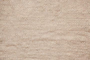 Fototapeta na wymiar Close up of knitting beige textured wool background