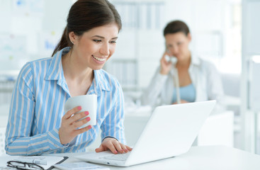 Business woman sitting with laptop