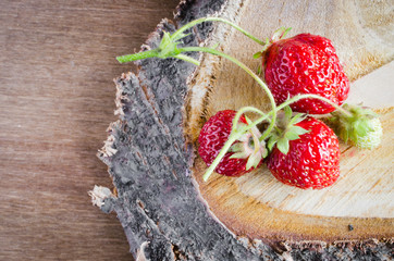 Fresh organic strawberry on wooden background.