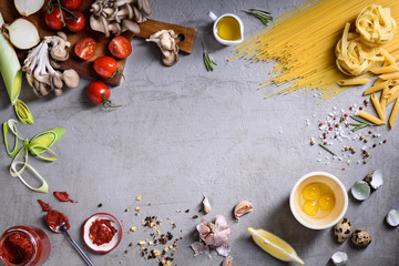 Pasta asortment with veggie ingredients. Italian ciusine feast food frame. Top view, copy space.
