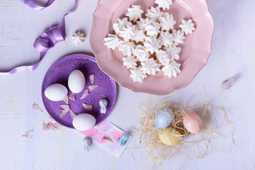 Easter colored eggs, chicken egg, sweet dessert. Pastel colors holiday style. Top view, space for text.