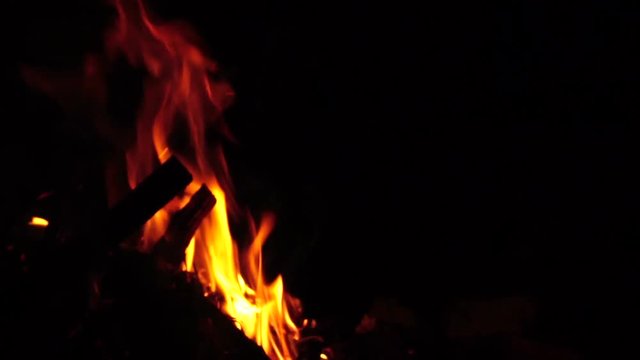 spurts of flame. Campfire in the night. Slow motion

