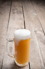glass beer on wood background