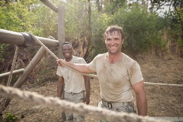 Portrait of military soldiers smiling during obstacle training
