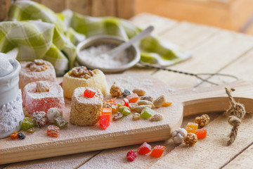 Obraz na płótnie Canvas Set of rahat lokum with candied peels, nuts and sugar powder