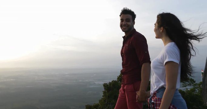 Couple At Mountain Top Holding Hands, Latin Man Showing Woman Morning View Point Finger Slow Motion 60
