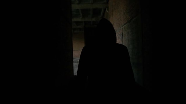 Lonely junkie in hood walks in dark catacombs in 4K