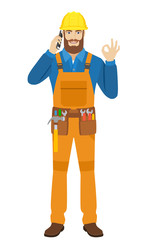 Worker talking on the mobile phone and shoing a okay hand sign