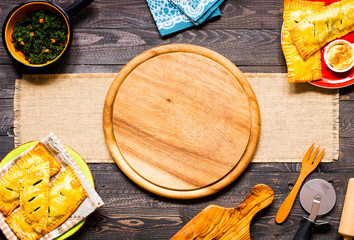 Delicious pie with spinach, made at home, on a wooden background,