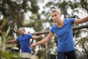 Fototapeta premium Fit man and woman during obstacle course training